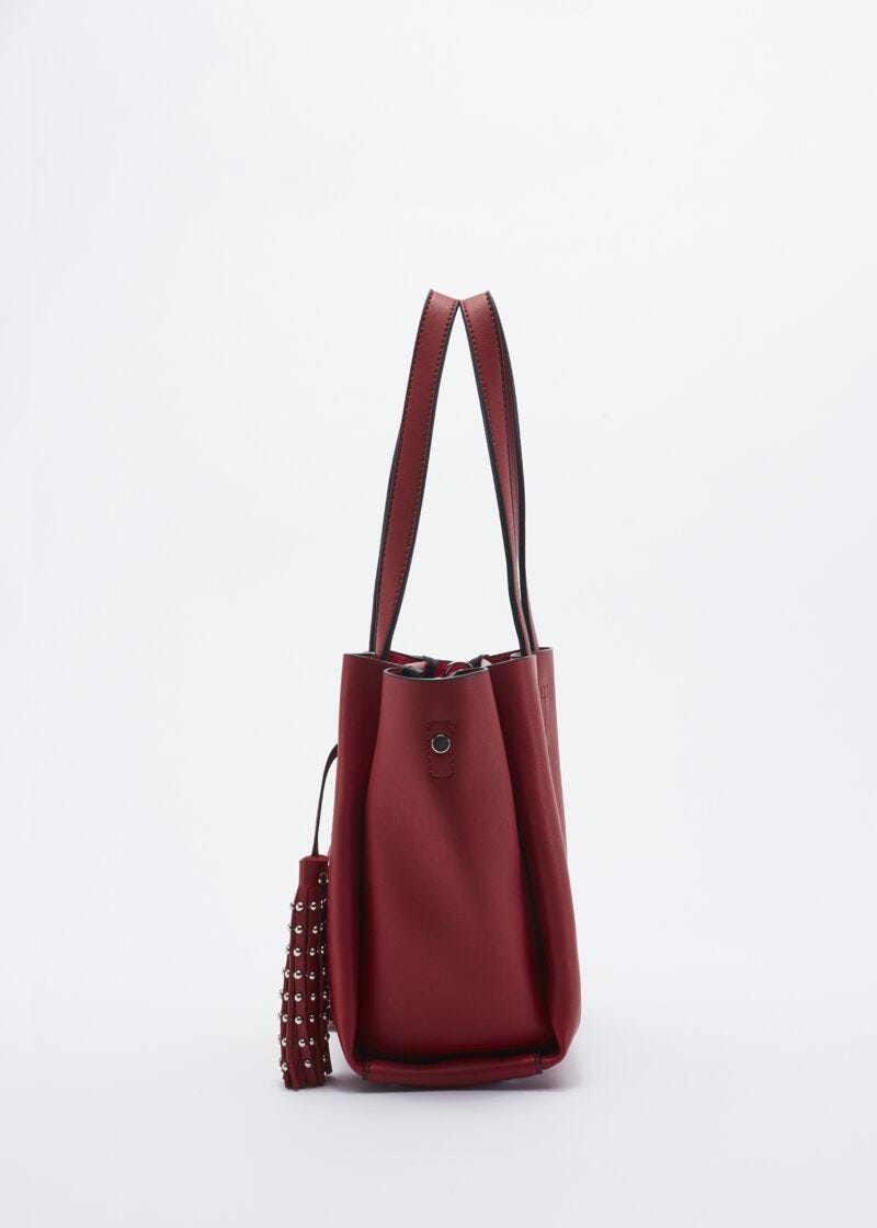 Bag with studded hanging tassels