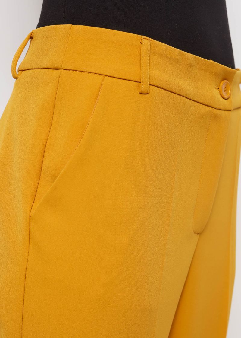 Trousers with ironed pleats