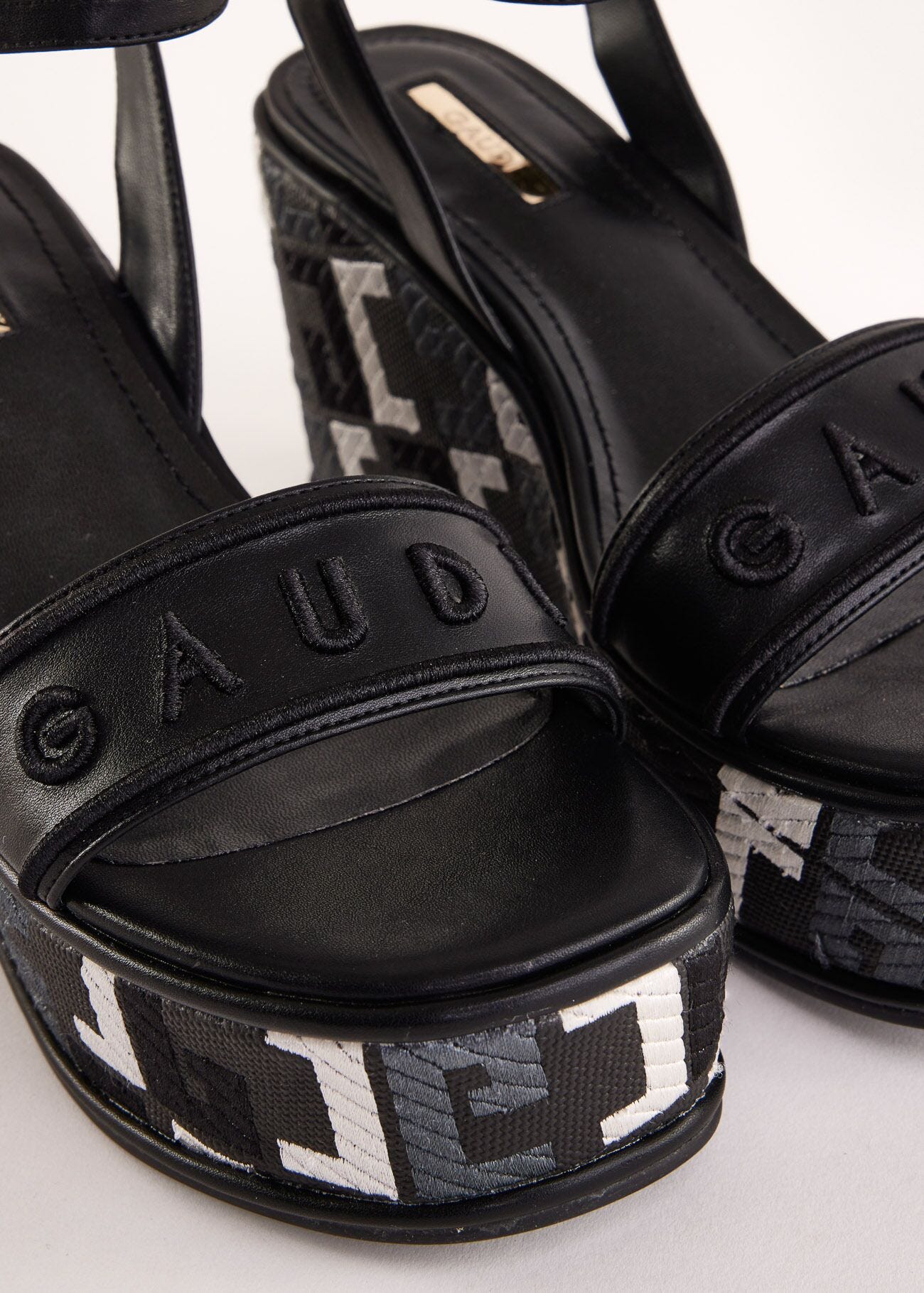Black faux-leather sandals with logo